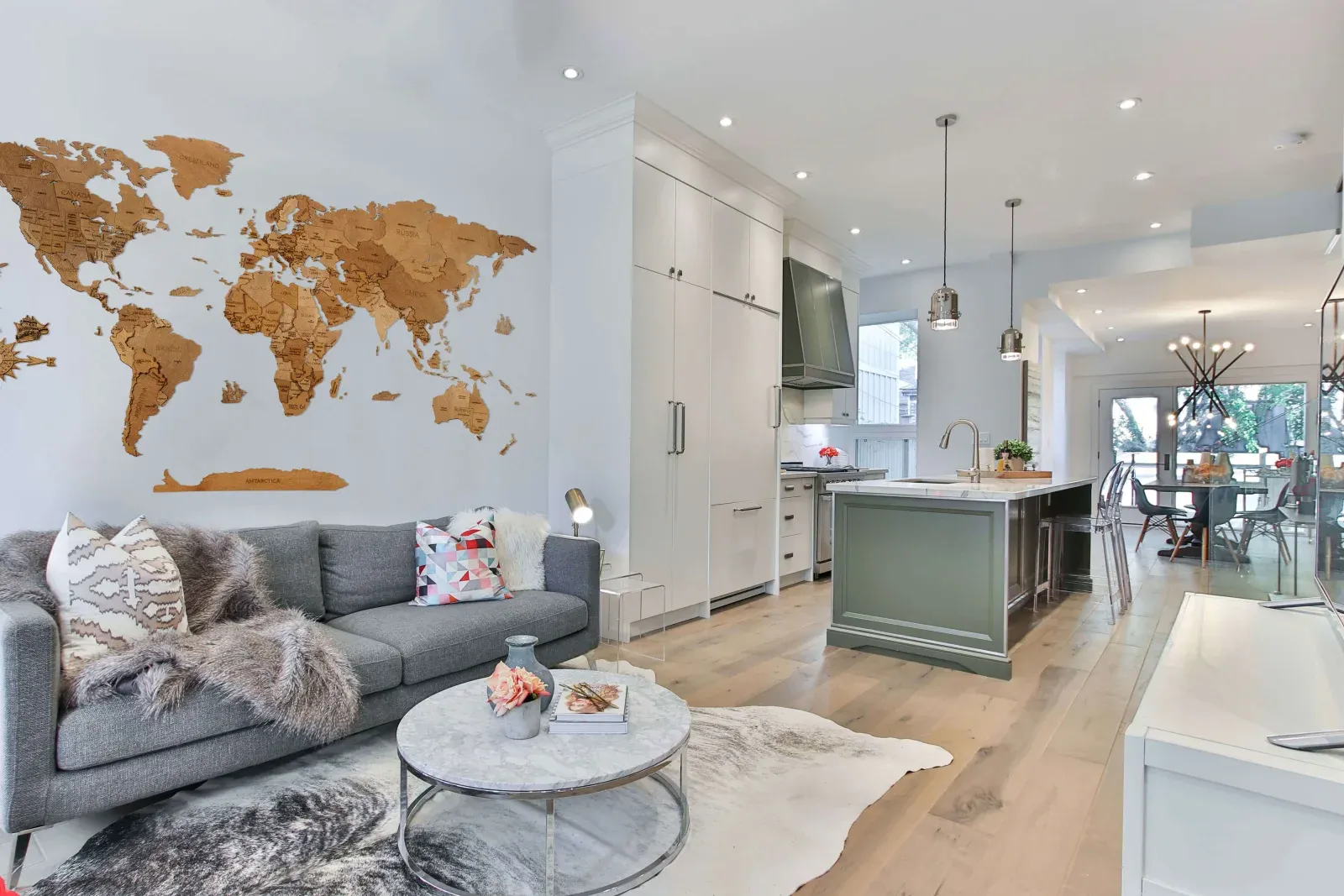 Manufacturer image used for editorial comparison; source and rights metadata retained in the image library. A walnut wooden world map in a light open-plan room