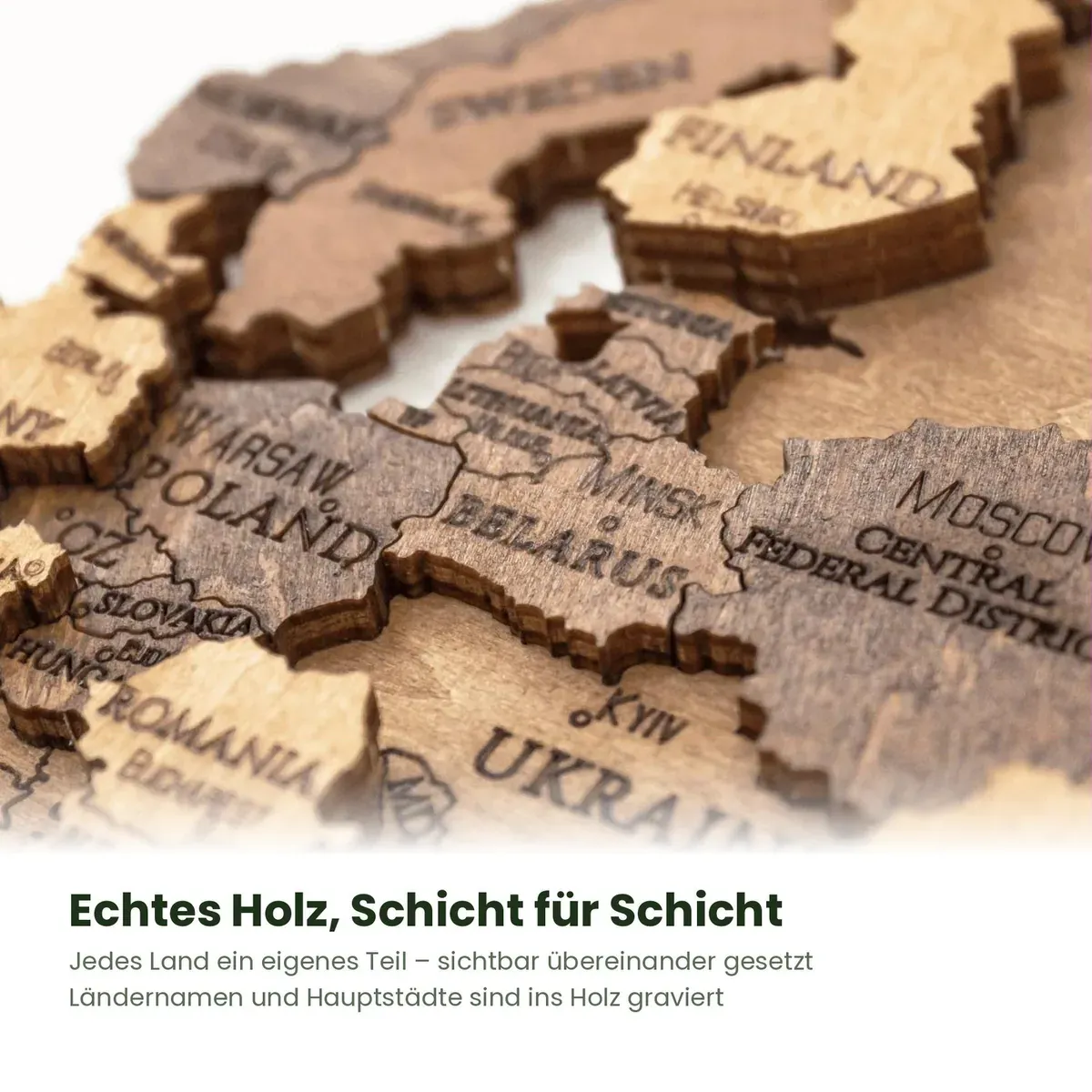 Macro view of stacked engraved wooden country pieces on the MagicHolz world map puzzle